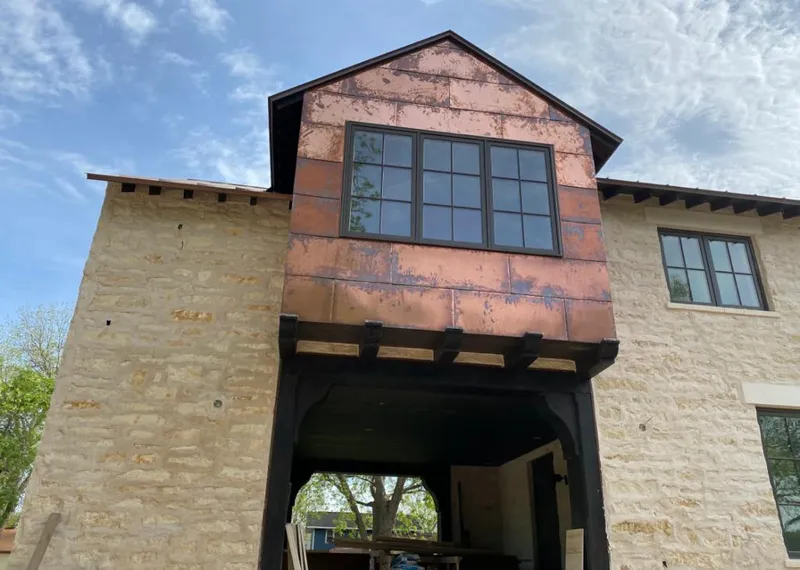 Copper metal panel facade on a stone building for Skylight Installation in Pingree Grove